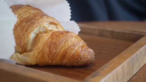 croissant and pastry in paper bag