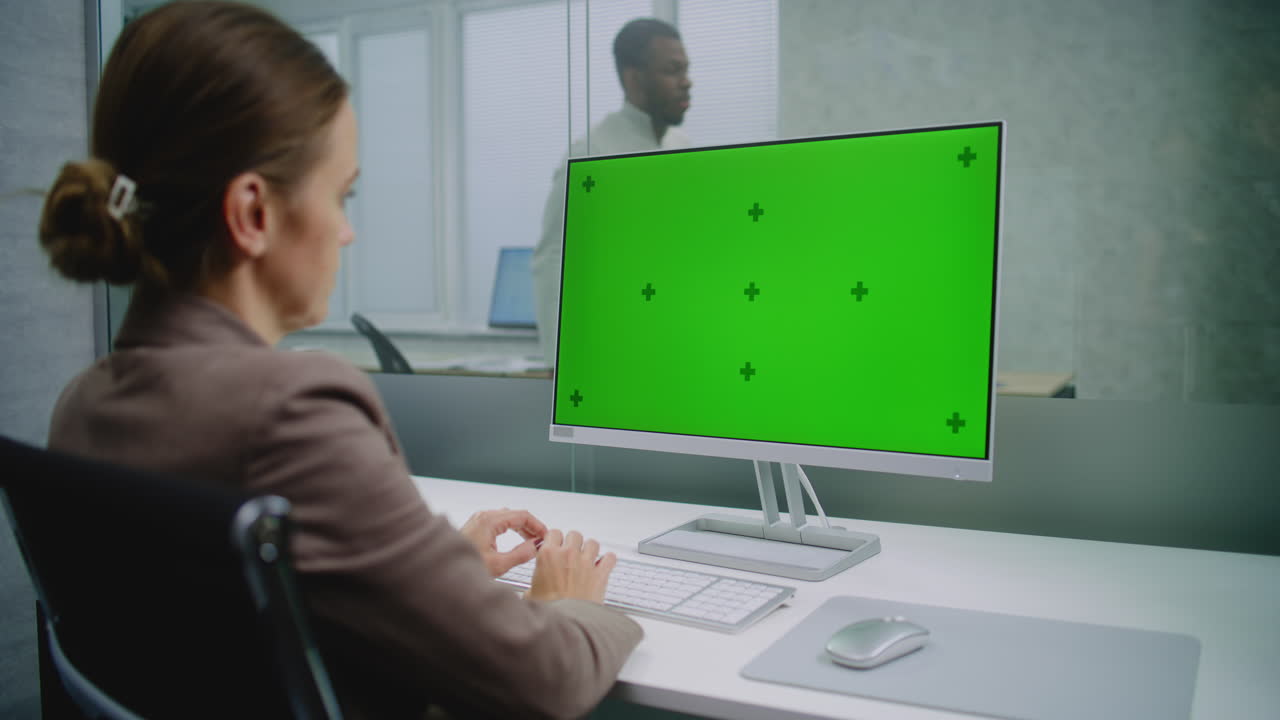 초록색 화면 을 가진 컴퓨터 에서 일 하는 사업가