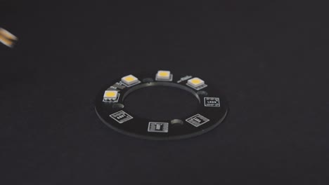 Manually Placing Electronics Components on Black PCB Side View
