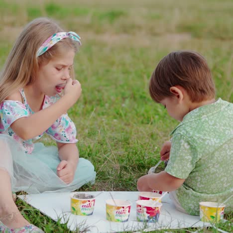 children sitting on green grass