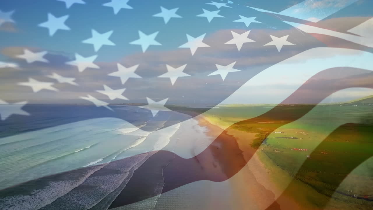Composição digital de bandeira dos EUA tremulando contra vista aérea da praia e ondas do mar.