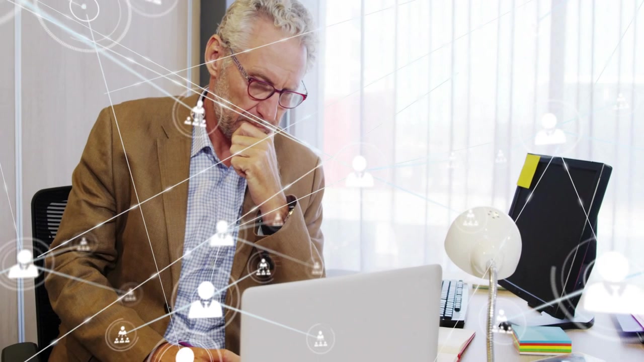 Man shifting thinking to typing on laptop, network overlay growing on desk, driving tech decisions