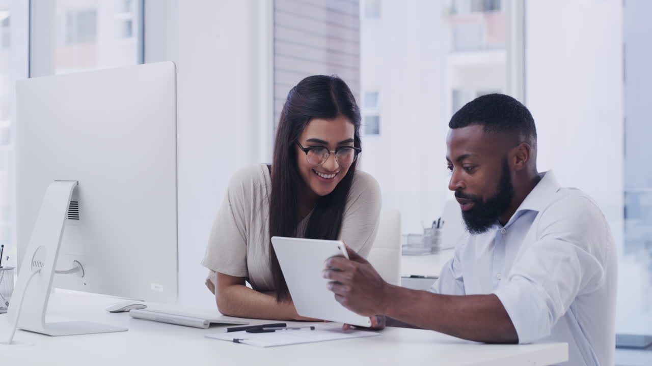 two businesspeople working together in an office