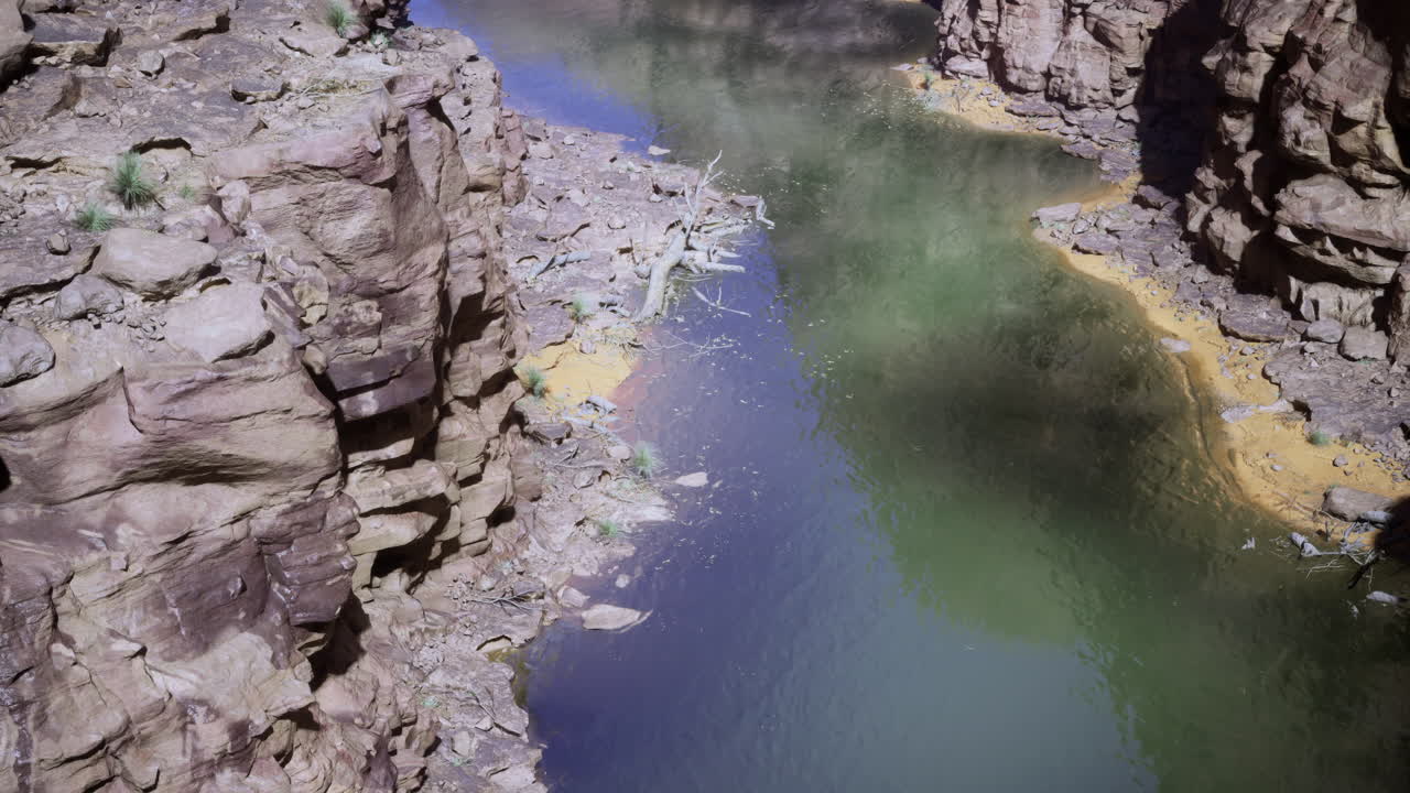Rocky riverbed with clear water and unique rock formations in daylight