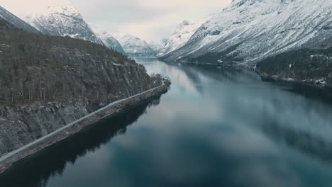 Majestic-Nordic-landscape-with-snow-covered-mountain-peaks-in-Norway,-aerial-view