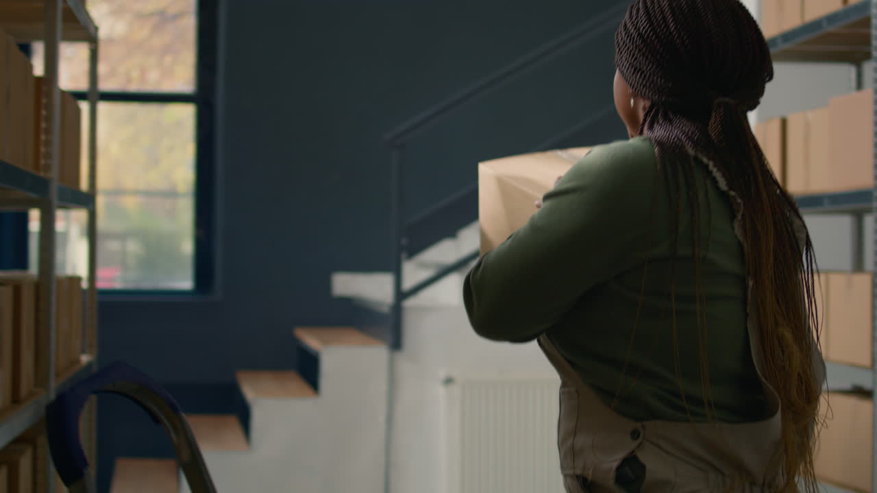 A woman working with cardboard boxes in a storage room