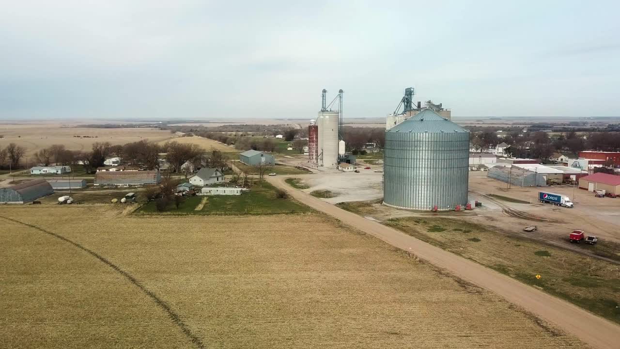 Aerial drone view of small town in rural Nebraska with agribusiness to support grain storage and sale - Bladen, Nebraska, USA