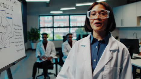 scientist giving a presentation on safety procedures in a lab setting
