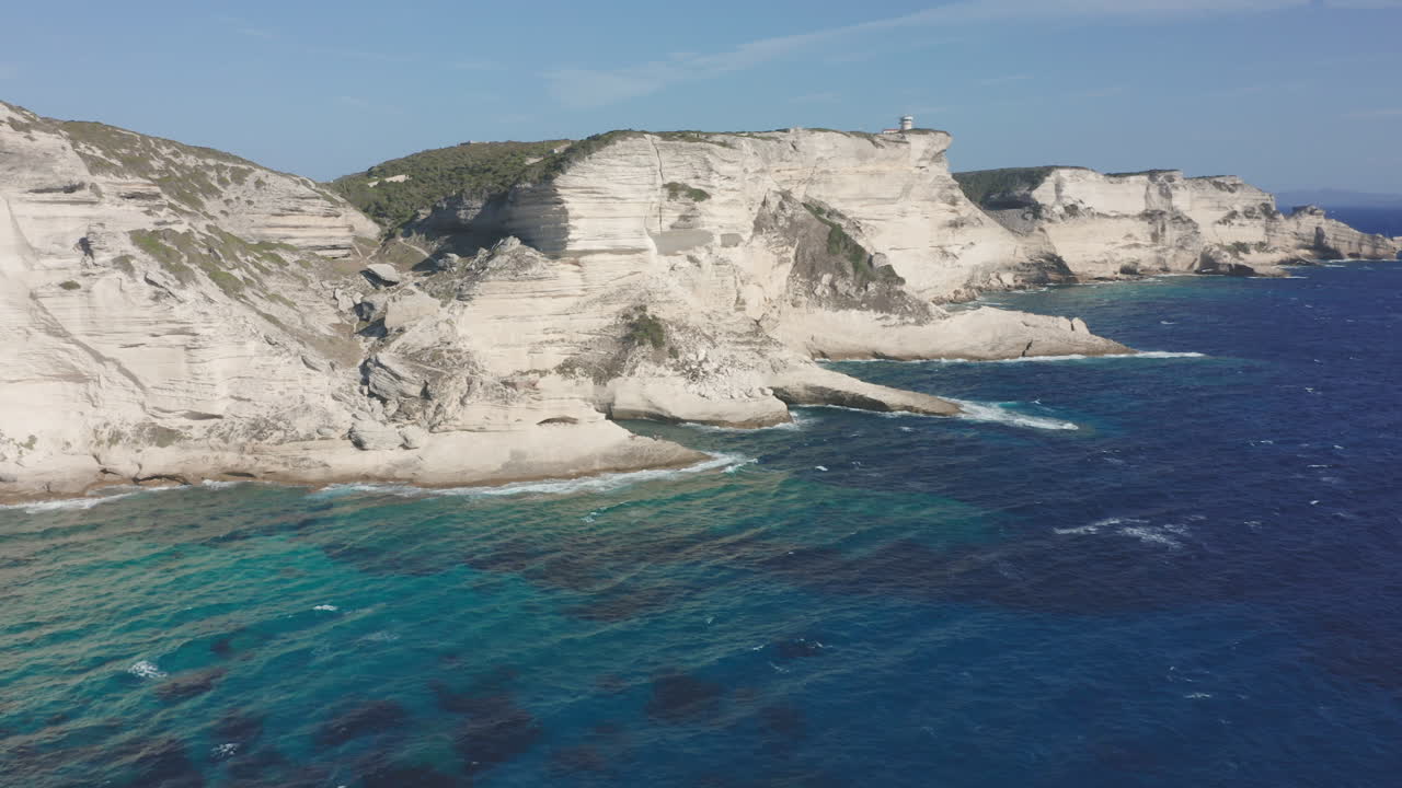Bonifacio, Corsica aerial drone circling shot cliffs at sunset lighthouse rugged coastline limestone the turquoise Mediterranean Sea iconic French island landscape