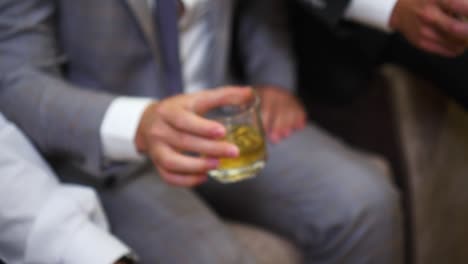 businessmen drink alcoholic beverages from beautiful glasses