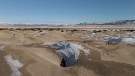 Aerial-flyover-snowy-Little-Sahara-Desert-with-Sand-Dunes-in-winter