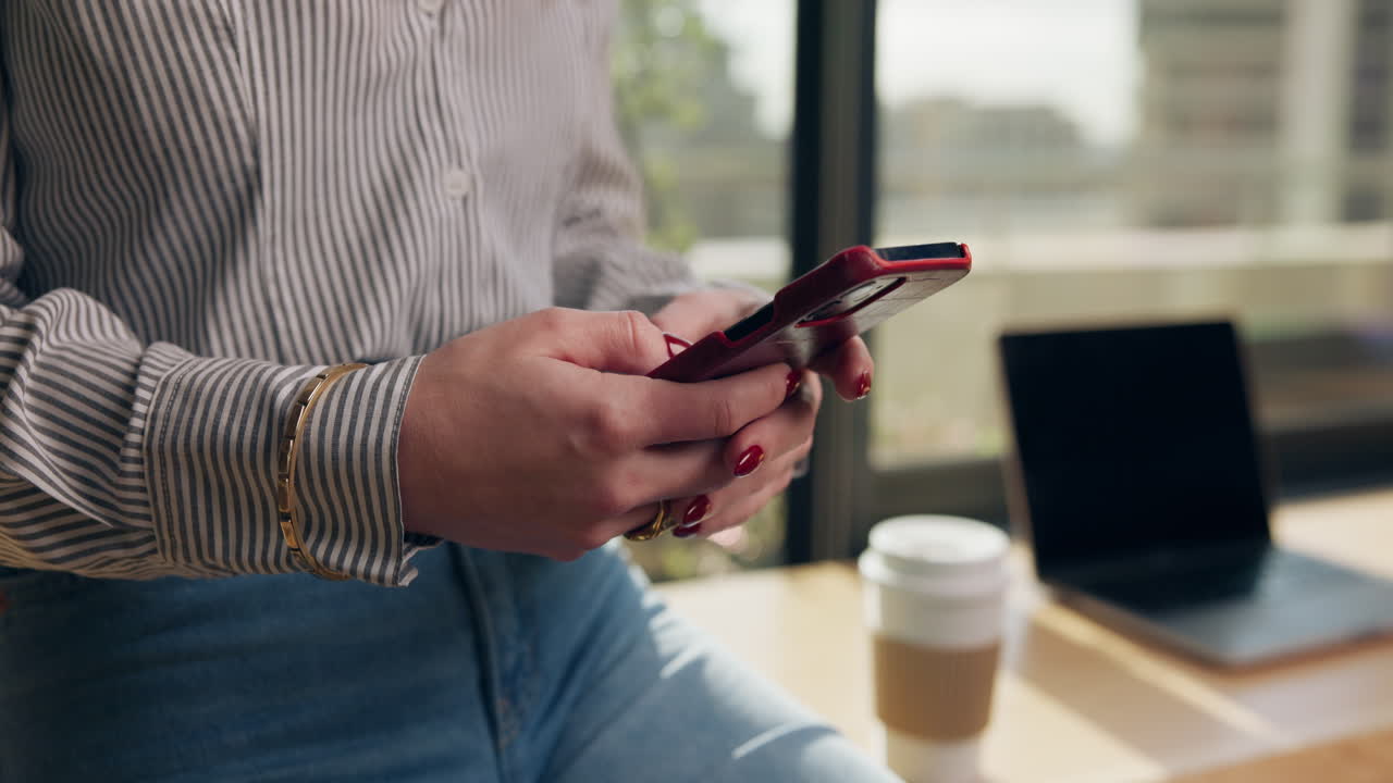 Woman using phone at desk