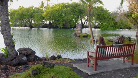 woman photographer at mauna lani fish ponds, hawaii
