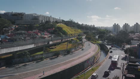 Aerial-landscape-image---Flying-over-slum-subway-rail-in-district-of-Capão-Redondo,-São-Paulo-City-in-Brazil