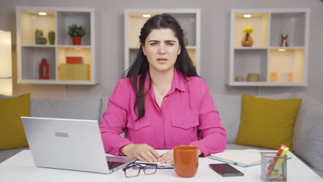 home office worker woman looking annoyed at camera.