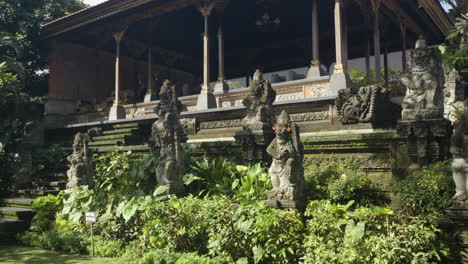 royal pavilion facility inside ubud palace decorated with ancient snote statues, officially puri saren agung - historical building complex in ubud, gianyar regency of bali, indonesia