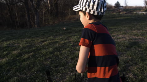 portrait of a young boy shoots an arrow from bow