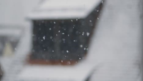 static shot of snow falling gently on a blurred background