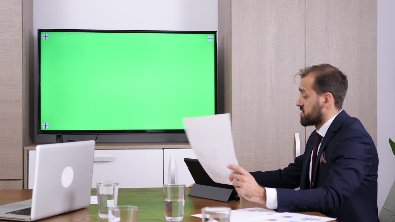 Business meeting with green screen display
