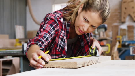 serious carpenter using measure tape