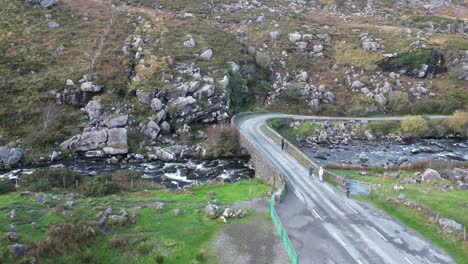 drone shot of gap of dunloe, bearna or choimín, mountain pass in county kerry, ireland