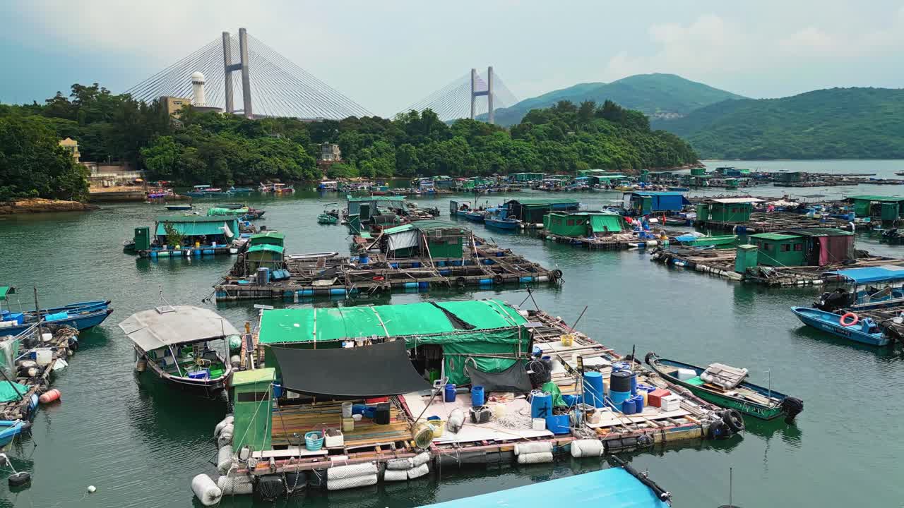 Aerial over the fishing boats and rafts of the fish farms on Ma Wan island, Hong Kong, China