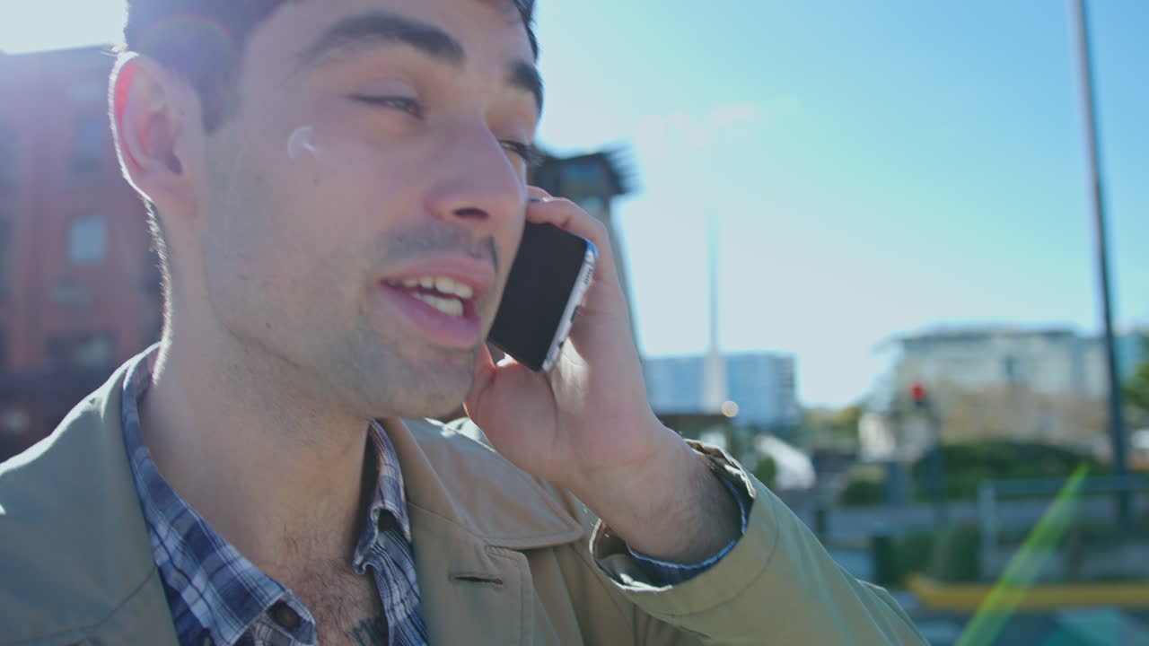 Young Man Speaking on Mobile Phone in the City