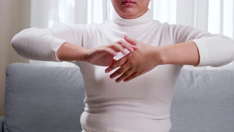 Detail-of-woman-performing-hand-stretching-due-to-constant-use-of-technologies