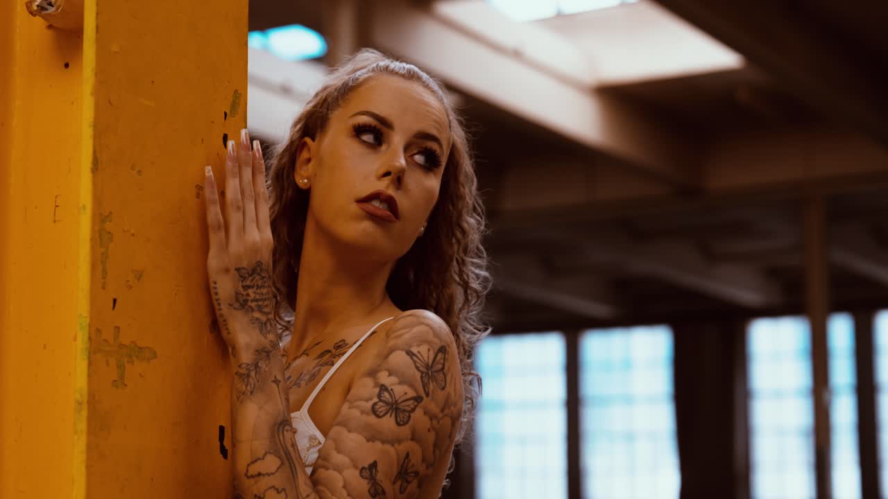 beautiful young woman poses at a shooting. flash visible from the camera