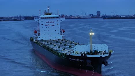 empty-cargo-ship-leaving-the-harbor,-aerial-tracking