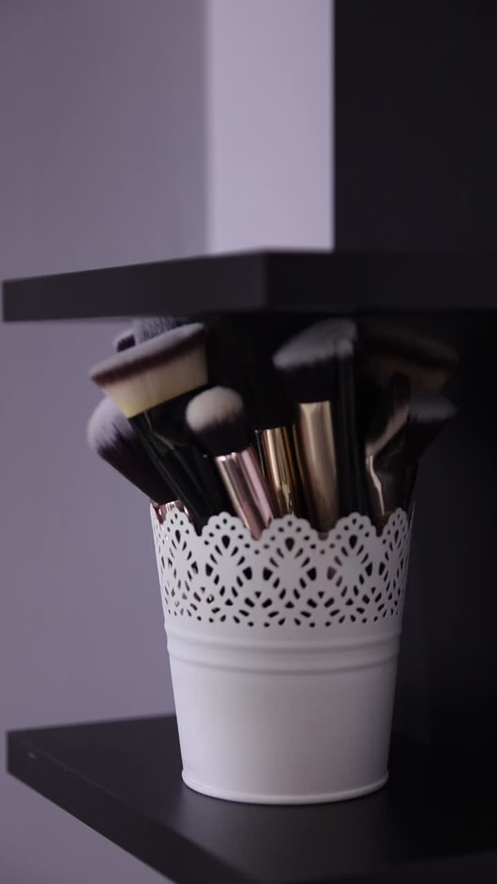 Makeup Brushes in a White Pot on a Shelf