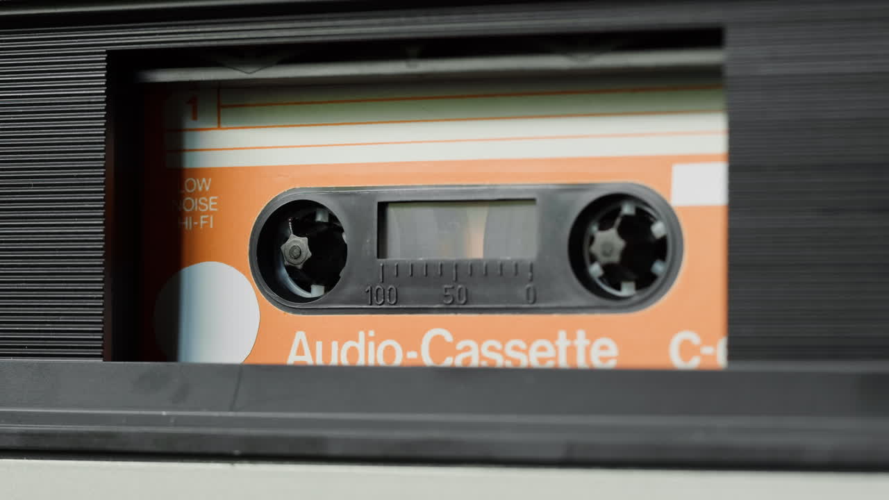 Close-up of an Audio Cassette in a Tape Player