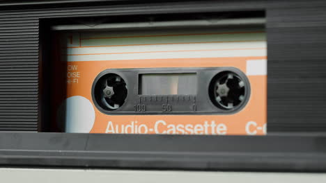 close-up of an audio cassette in a tape player