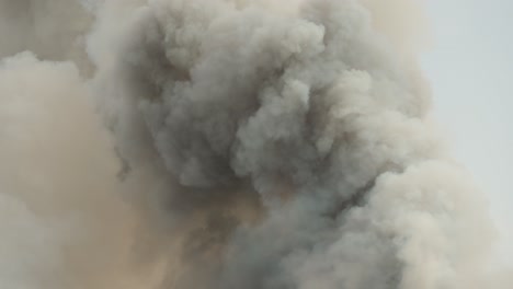 black smoke clouds and flames rise into the sky.