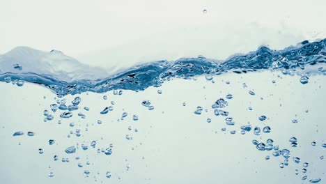 Many-bubbles-in-water-close-up,-abstract-water-wave-with-bubbles-in-slow-motion