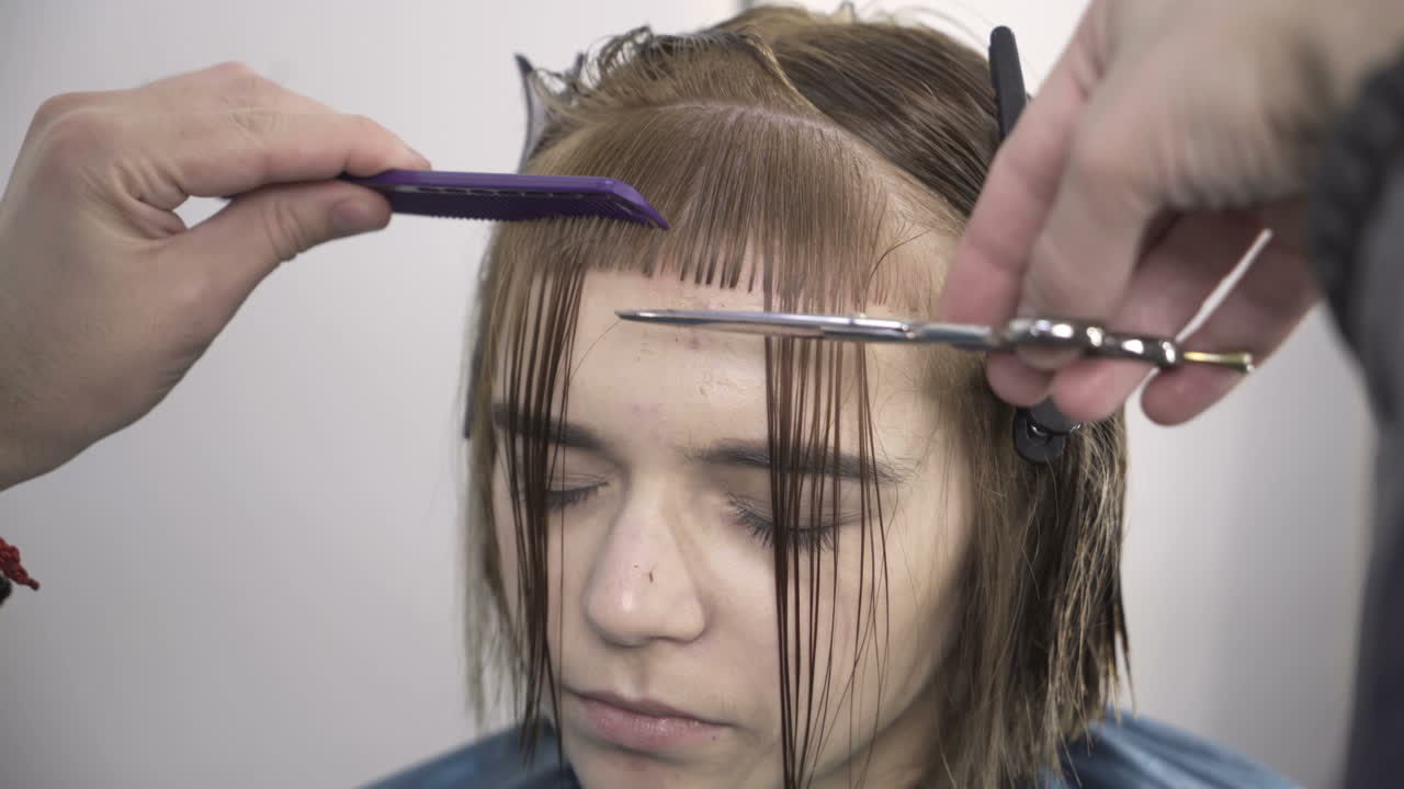 Hairdresser dying female hair. Woman client hair in beauty parlour hairdressing salon