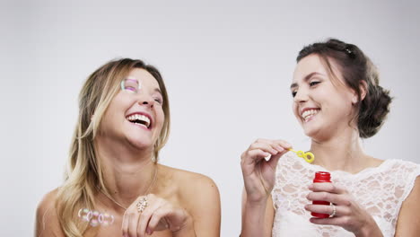 two friends having fun with bubbles