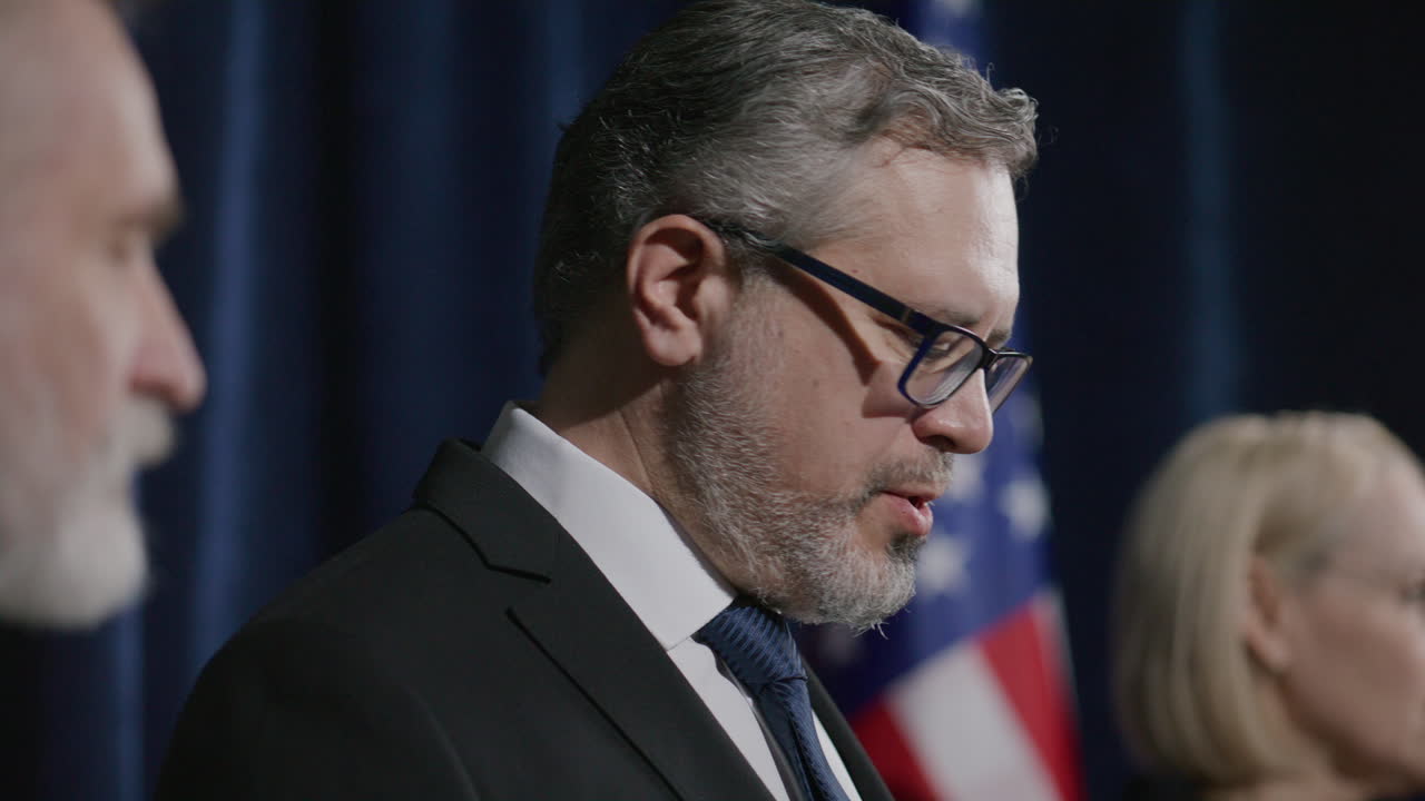 Middle-aged Politician Speaking to Audience during Official Press Event