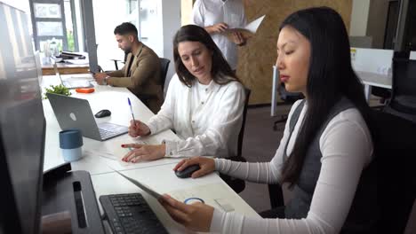 women reading documents in office