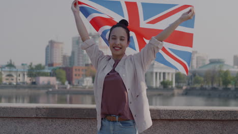 woman holding british flag outdoors