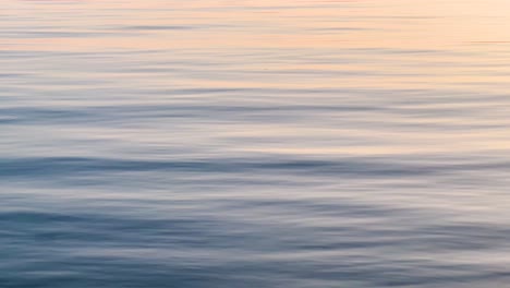 closeup of blue sea water with ripples during golden hour: a tranquil seascape