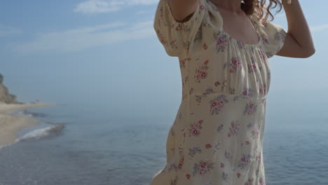 Happy-girl-jumping-sea-water-in-straw-hat-summer-day-close-up.-Woman-have-fun.