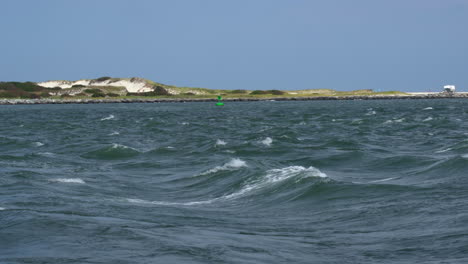 the rolling waves of the ocean at the barnegat light inlet