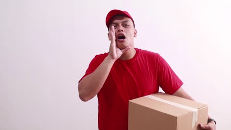 young asian courier man shouting calling while holding cardboard