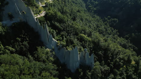 orbit drone shot of fairy chimney rock formations during the day in euseigne, canton of valais, switzerland