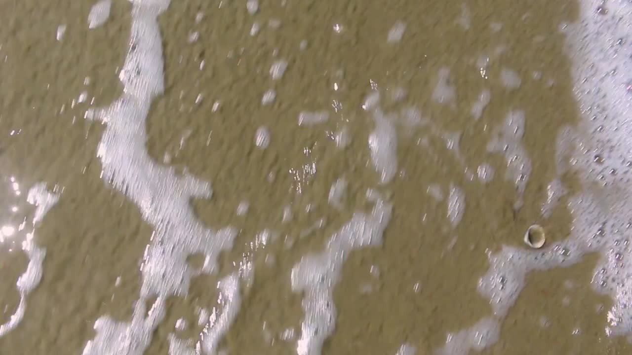 Peace washed away by water from the ocean beach