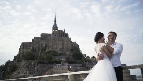 couple in love kissing in front of a monastery