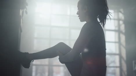 bodybuilder stretching leg after training. woman getting ready for exercises