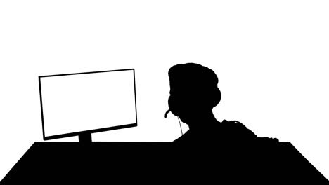 silhouette back shot of competitive young man playing online games on computer