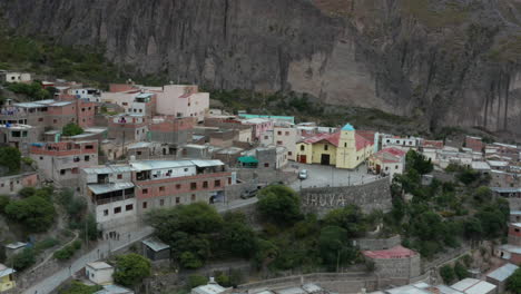 Aerial---Iruya-town-church,-Andes-mountains,-Argentina,-wide-forward-shot